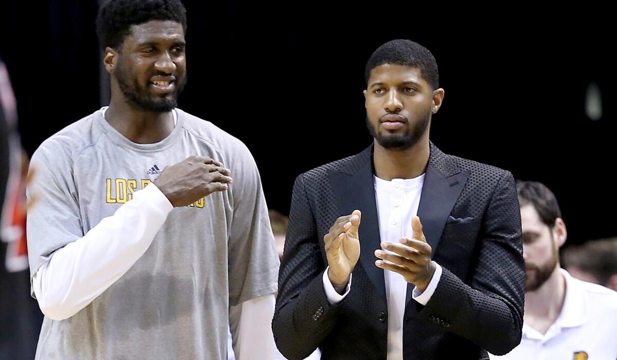 Paul George, right, is hopeful he can rejoin center Roy Hibbert and the rest of the Pacers soon.