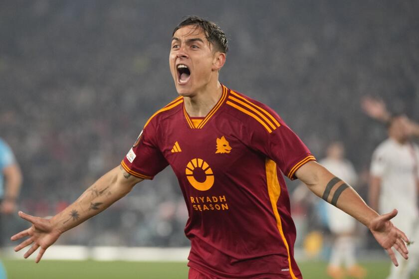 Roma's Paulo Dybala celebrates after scoring his team's secnd goal during the Europa League quarterfinal second leg soccer match between Roma and AC Milan, at Rome's Olympic Stadium, Thursday, April 18, 2024. (AP Photo/Andrew Medichini)