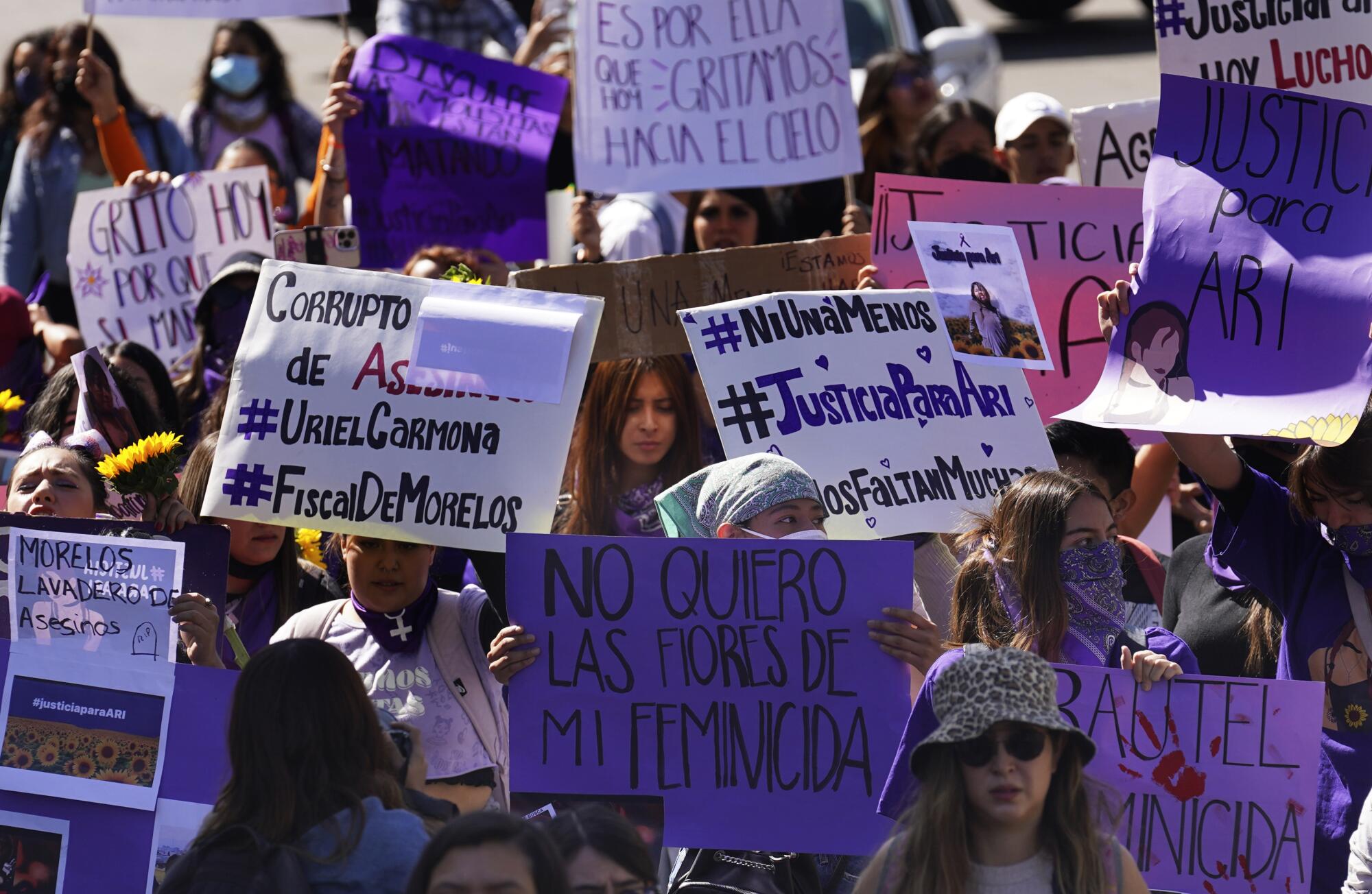 Members of feminist groups march in Mexico City to protest the slaying of Ariadna Lopez.