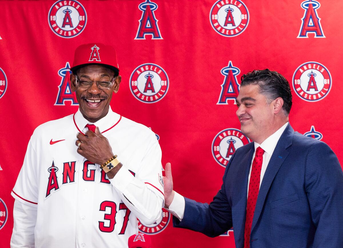 Angeles general manager Perry Minasian, right, and manager Ron Washington speak during a news conference.
