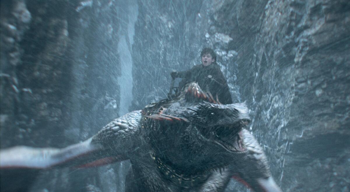 A young prince rides his dragon around rocky cliffs in "House of the Dragon."