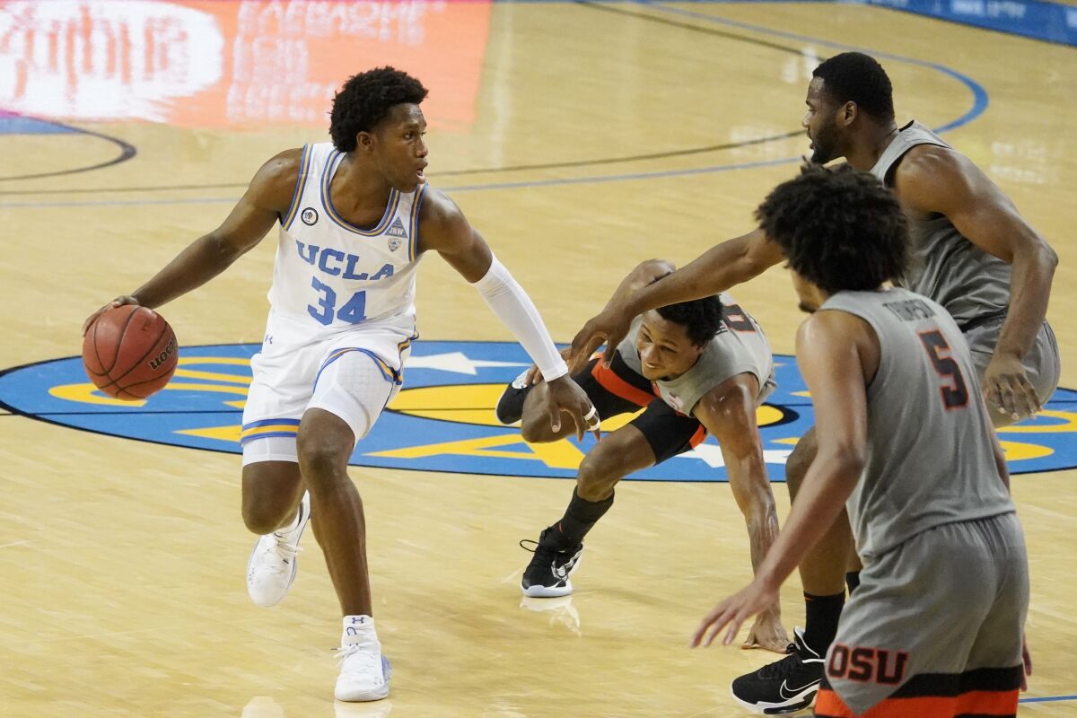 UCLA's David Singleton (34) handles the ball against Oregon State during the second half Jan. 30, 2021.