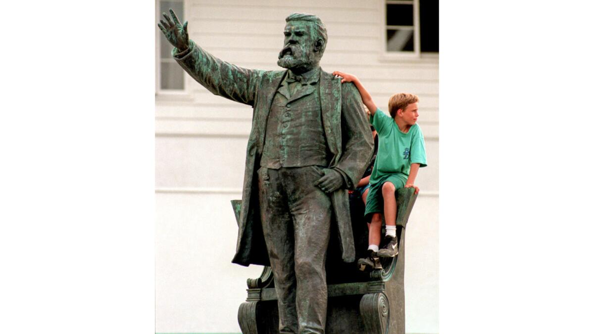 July 20, 1994: Patrick Rozelli, 11, hangs out at the statue of Stephen M. White overlooking Cabrillo Beach in San Pedro.