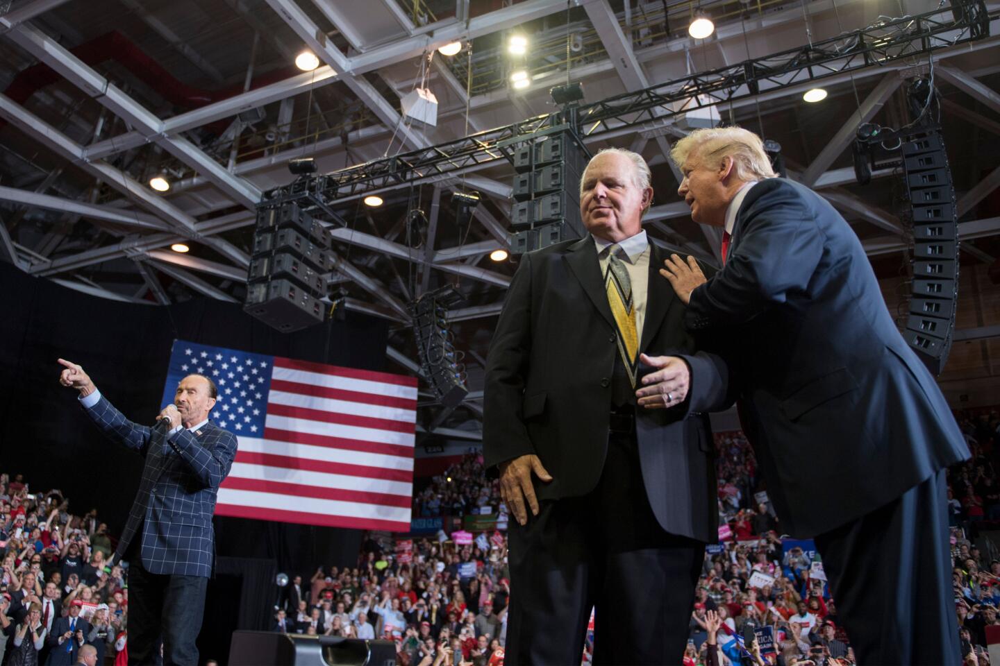 Trump speaks to Limbaugh at a rally.