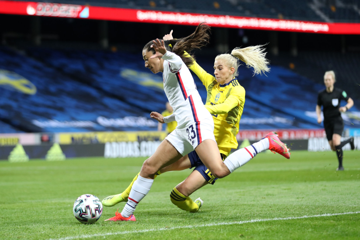 Christen Press of United States is challenged by Sofia Jakobsson of Sweden.