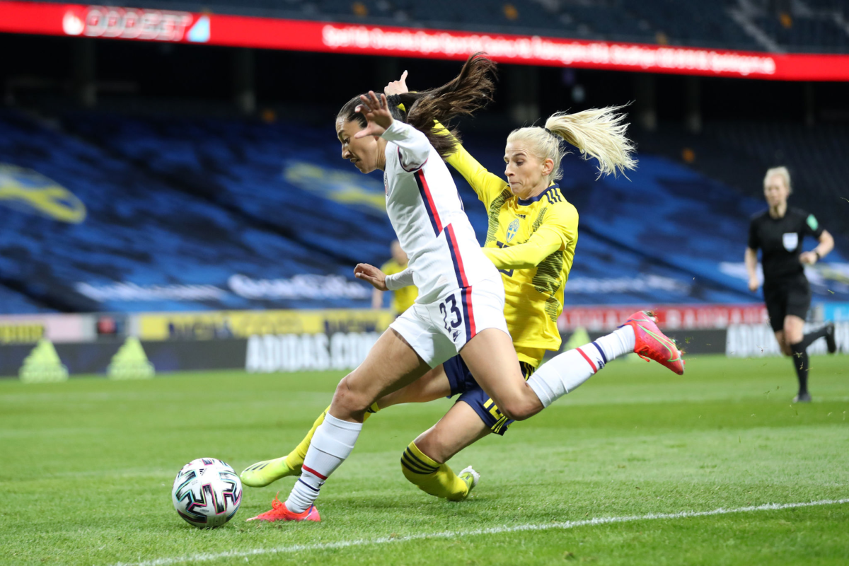 U.S. forward Christen Press is challenged by Sweden forward Sofia Jakobsson.