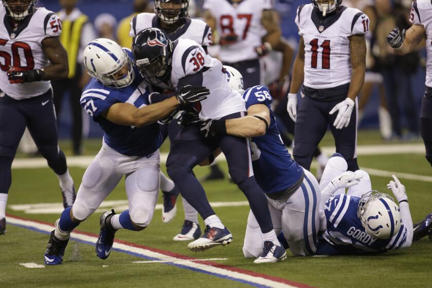 The Houston Texans' Danieal Manning (38) is tackled by the Indianapolis Colts' Josh McNary (57)in a game in December.