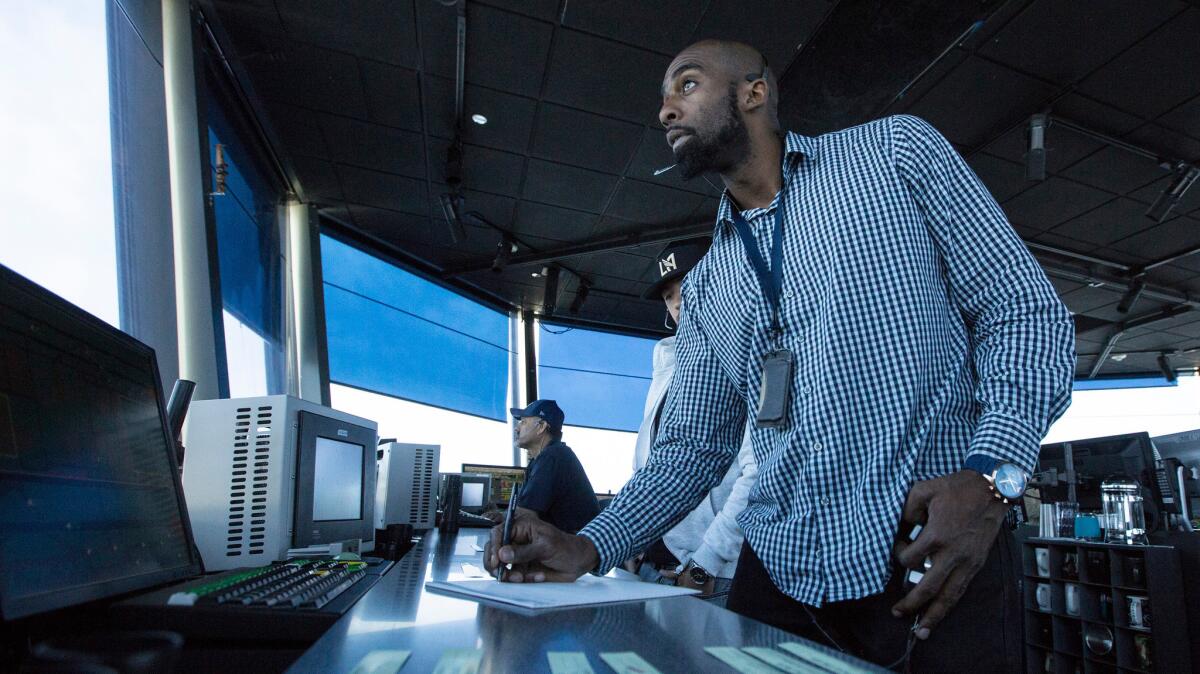 Air traffic controllers direct aircraft in the control tower cab at Los Angeles International Airport. The Federal Aviation Administration has turned to social media to fill 1,400 controller positions.
