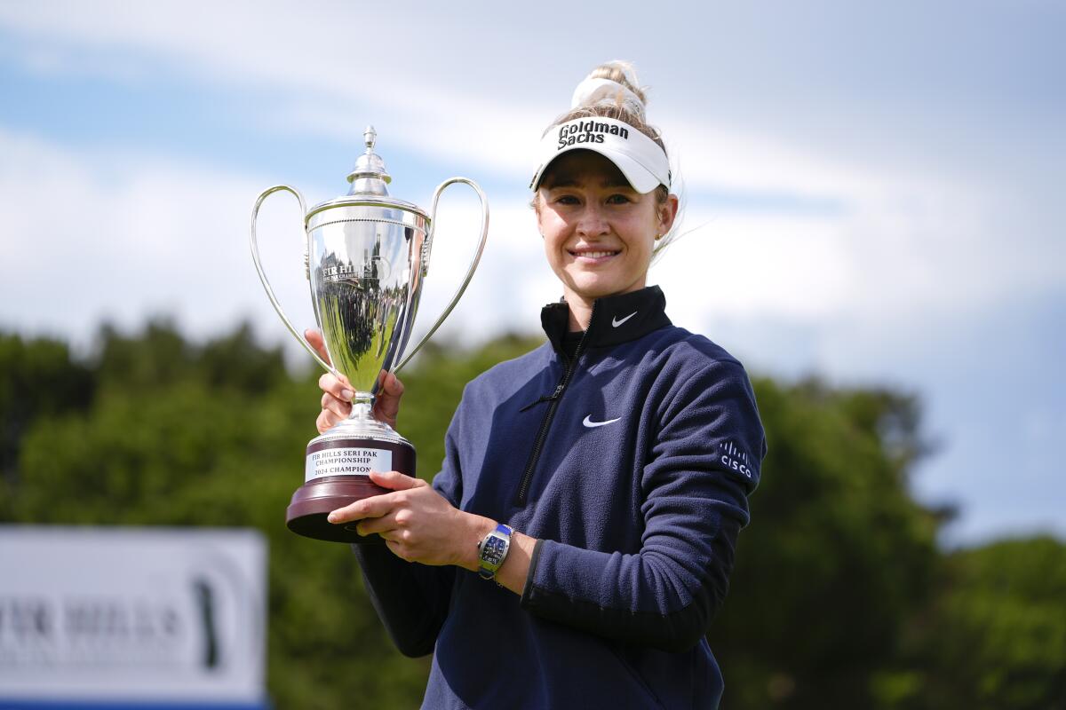 Nelly Korda holds up the trophy after winning the Fir Hills Seri Pak Championship.