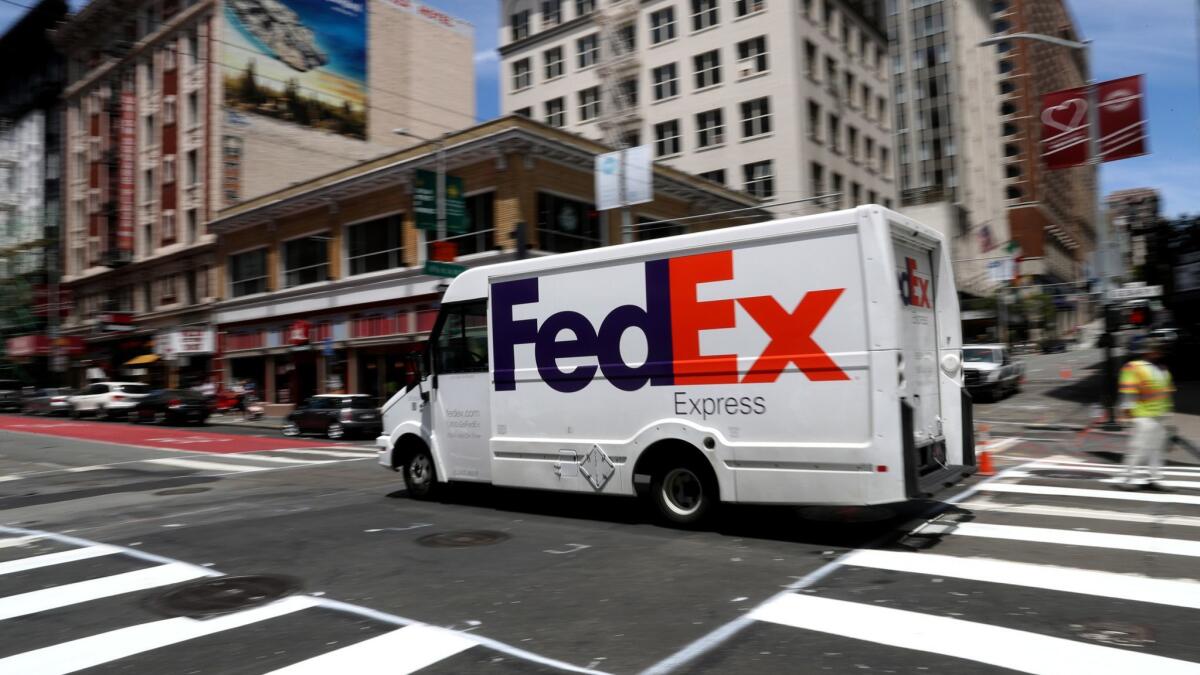 A FedEx delivery truck drives along Geary Street in San Francisco on Tuesday.