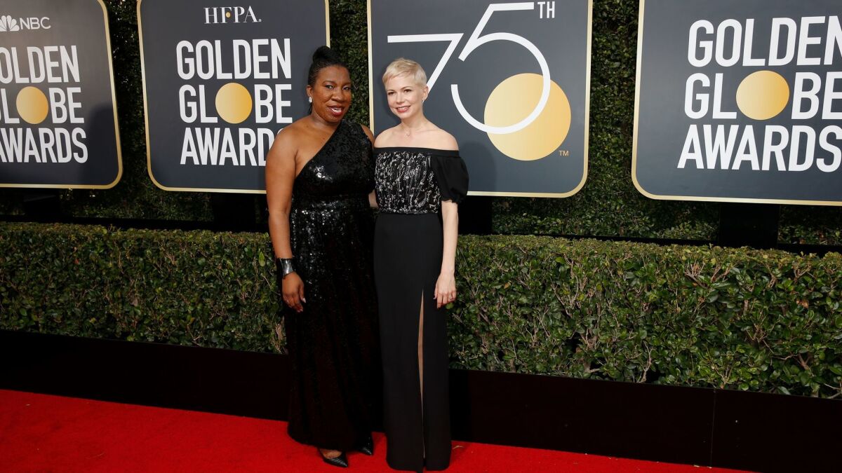 Tarana Burke, who founded the Me Too movement in 2006, left, and actress Michelle Williams appear on the red carpet at the 75th Golden Globes at the Beverly Hilton Hotel on Sunday.