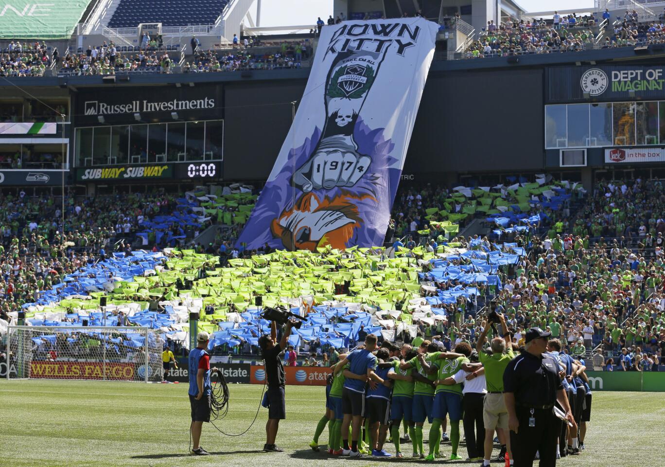 Seattle Sounders supporters show a tifo display that reads "Down Kitty" in reference to MLS Soccer's Orlando City FC's lion mascot before an MLS soccer match, Sunday, Aug. 16, 2015, in Seattle. (AP Photo/Ted S. Warren)