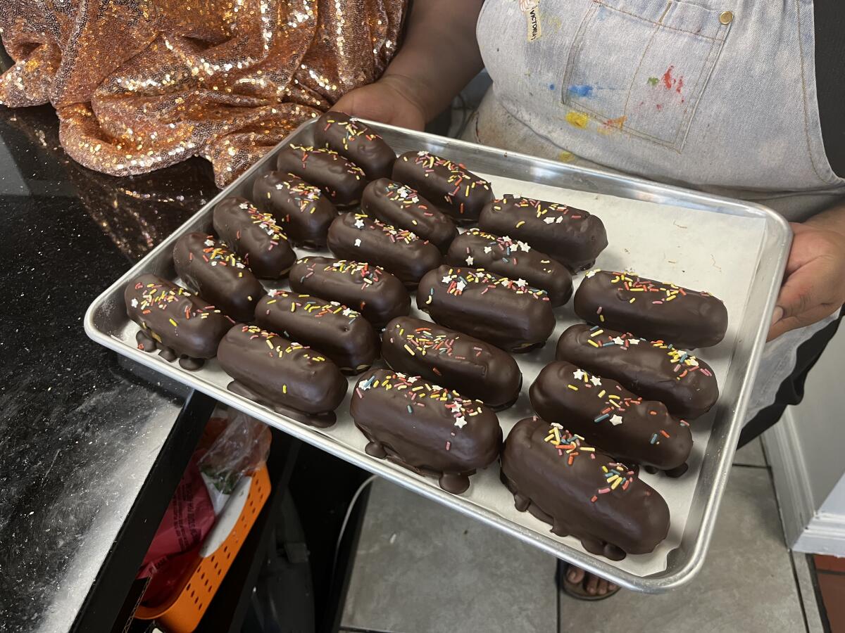 Kathy Lopez holds a tray of "vegansitos," a play on words for their vegan version of the popular Mexican Gansito snack cakes.