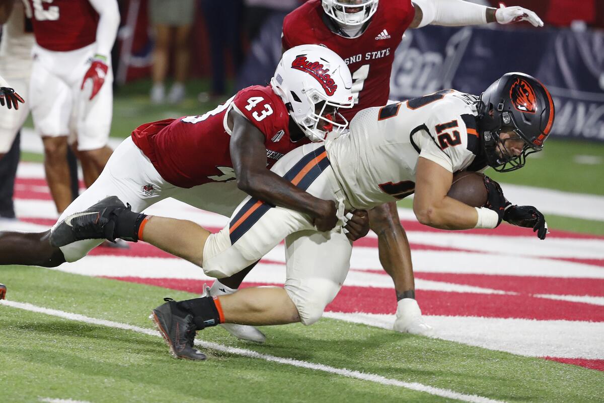 Oregon State linebacker and running back Jack Colletto heads in to the end zone for the game winning score as Fresno State defensive back Morice Norris tries to stop him during the second half of an NCAA college football game in Fresno, Calif., Saturday, Sept. 10, 2022. (AP Photo/Gary Kazanjian)