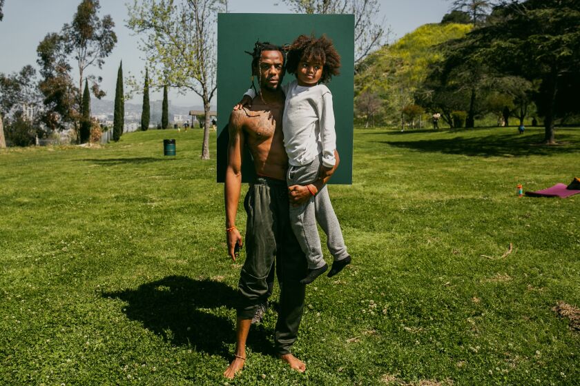Los Angeles, CA - April 02: Nardo Vanterpool and his son Prince Walker of Inglewood pose for a portrait at WalkGood LA's Vinyasa yoga flow session in Kenneth Hahn Park on Sunday, April 2, 2023 in Los Angeles, CA. (Jason Armond / Los Angeles Times)