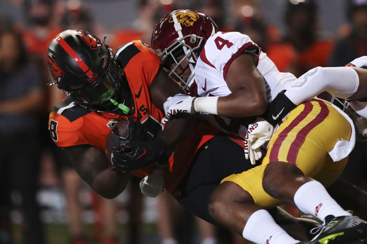 Oregon State running back Jam Griffin is brought down by USC defensive back Max Williams.