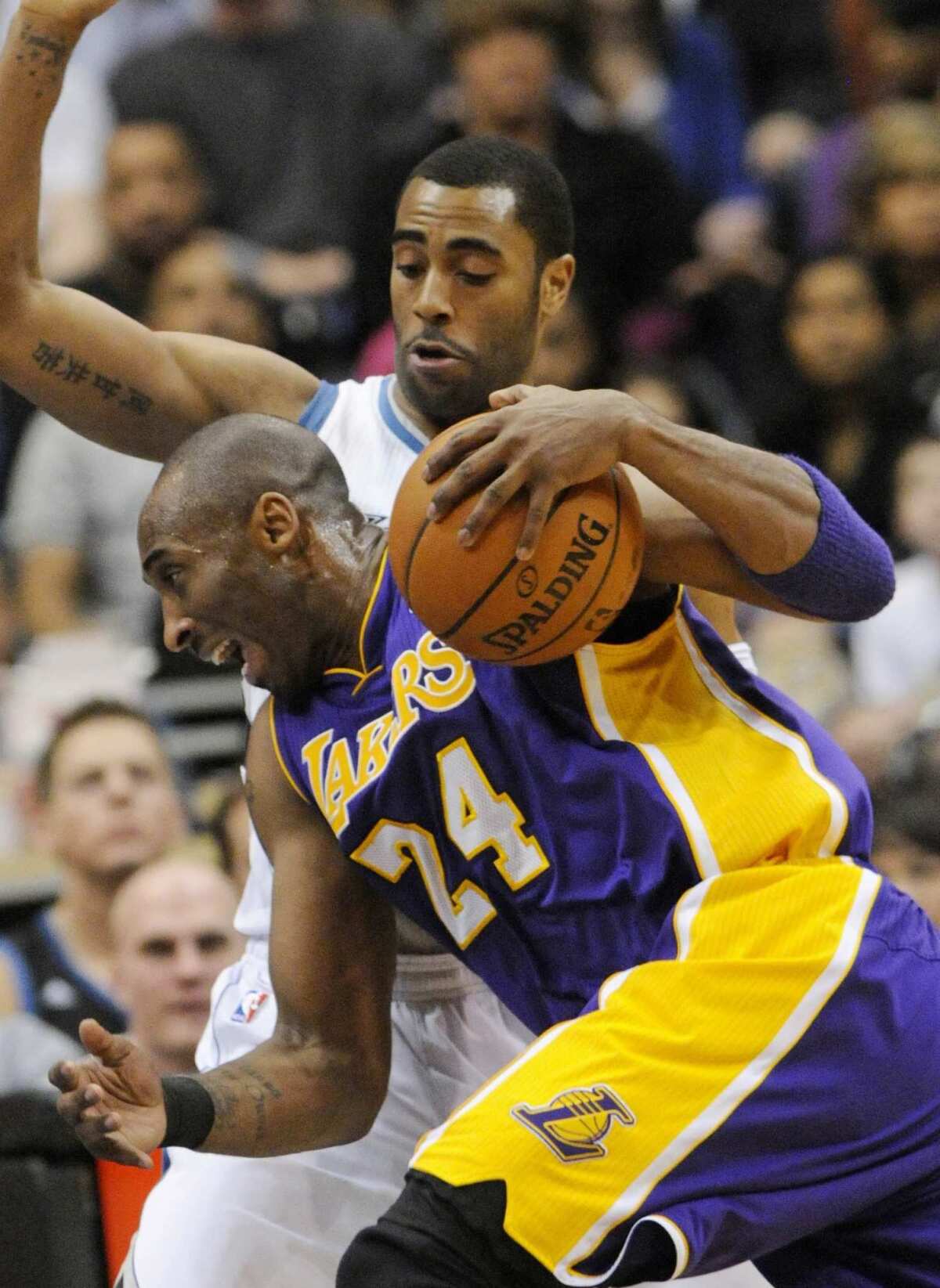 Guard Kobe Bryant tries to drive past then-Timberwolves guard Wayne Ellington, who signed Monday to join the Lakers.