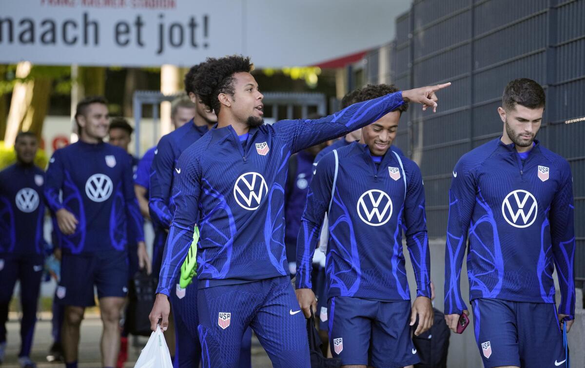 Weston McKennie, left, points as the U.S. men's national team arrives in Germany for a training session.