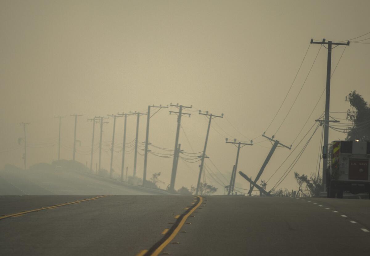 Power lines damaged by the Woolsey fire droop along the southbound Pacific Coast Highway near Leo Carrillo State Beach on Nov. 10.