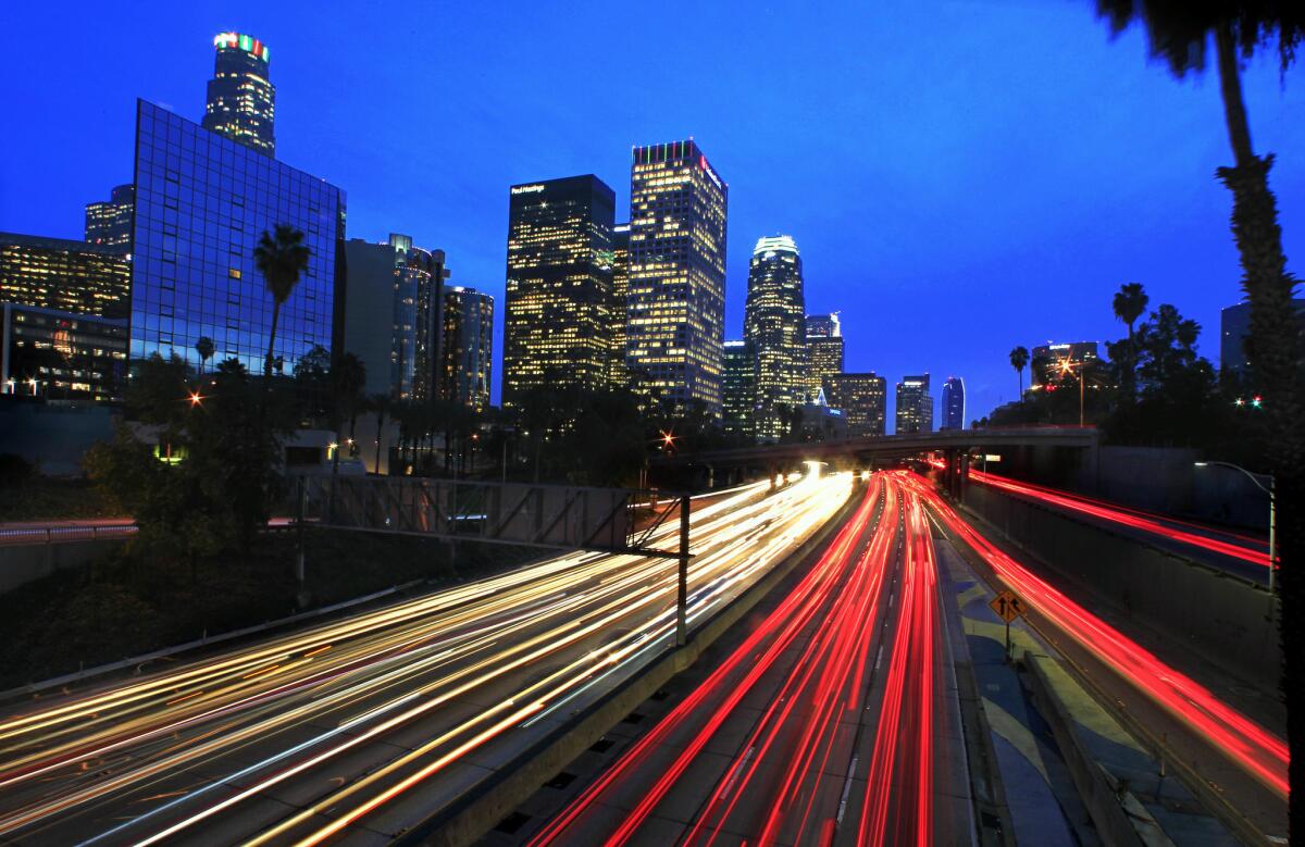 The glare of head and brake lights line the 110 Freeway during the evening rush hour. Faced with growing shortfalls in highway funding, California officials are trying to determine if a mileage fee would be more effective at raising revenue for road projects than the state gas tax.