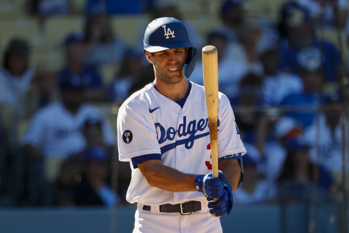 Los Angeles Dodgers' Chris Taylor (3) looks at his bat after swinging at a pitch by Arizona Diamondback.