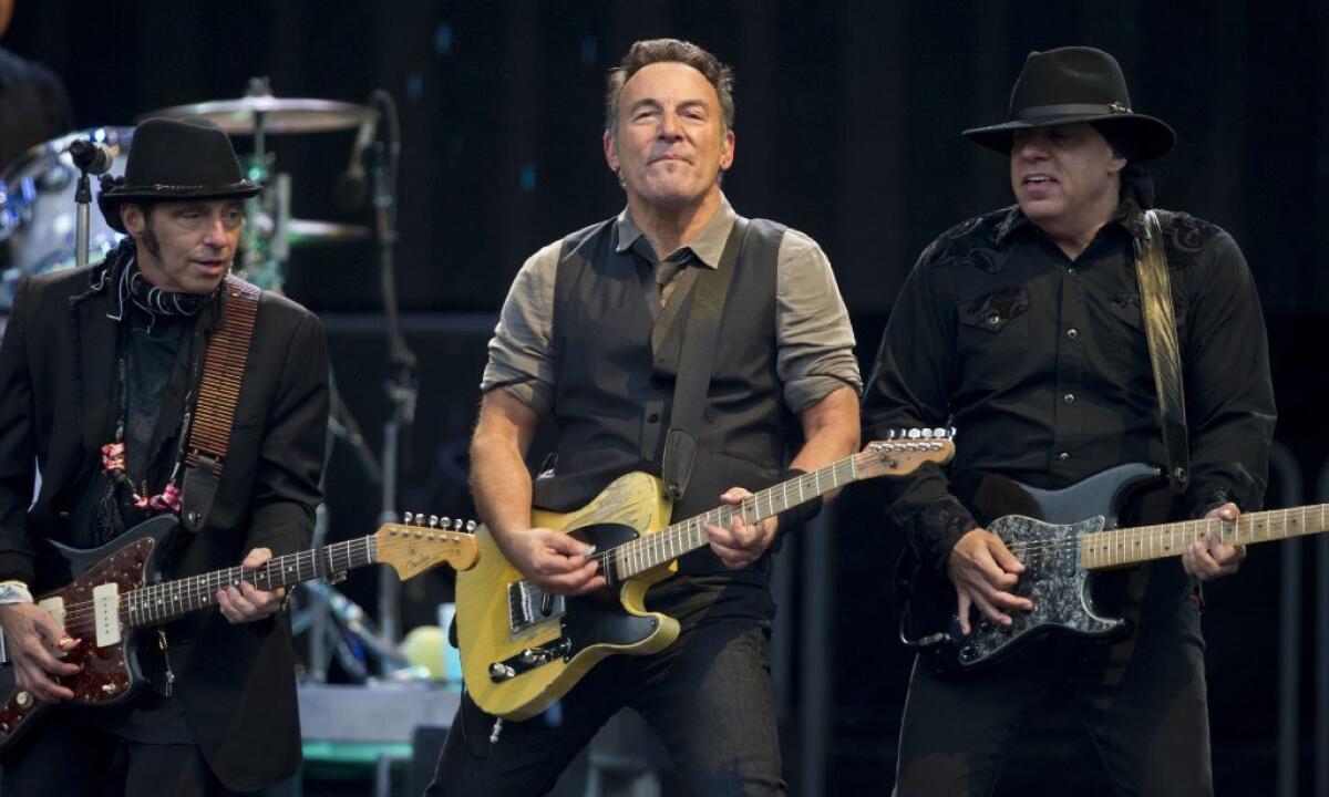 Bruce Springsteen, center, with guitarists Nils Lofgren, left, and Steve Van Zandt, dedicated the album 'Born to Run' to actor James Gandolfini during a show Wednesday in Coventry, England.