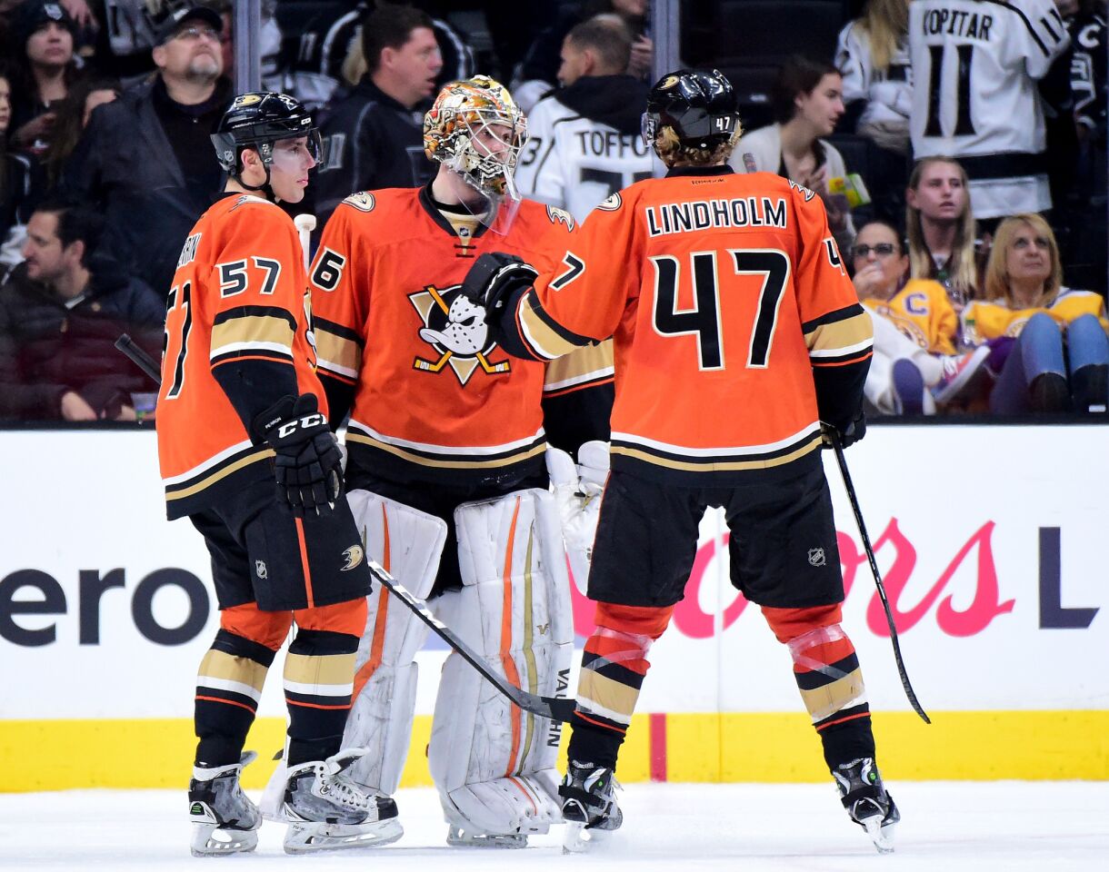 Ducks goaltender John Gibson celebrates the 4-2 victory over the Kings with left wing David Perron and defenseman Hampus Lindholm.