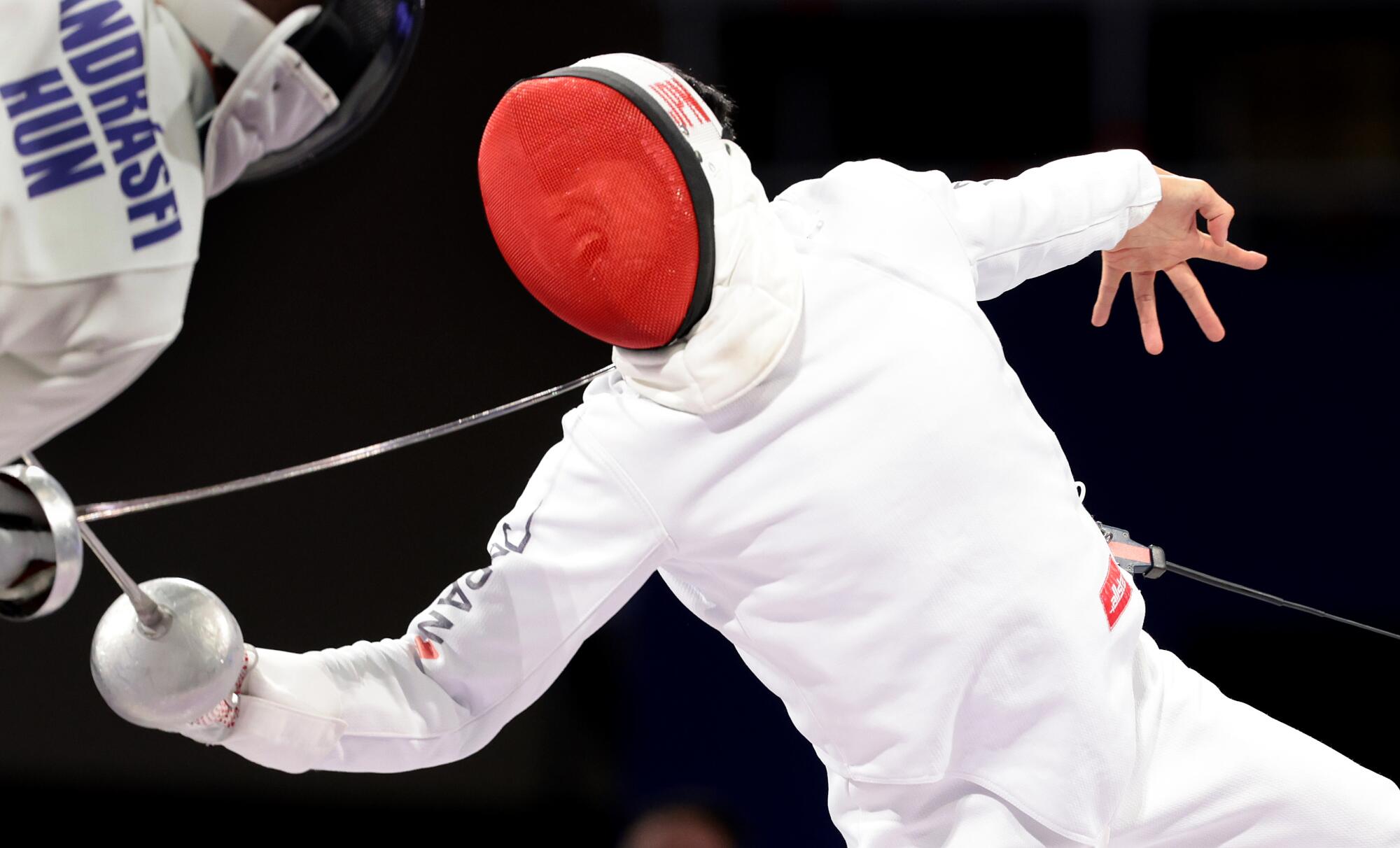 Japan's Koki Kano battles Tibor Andrasfi in the semifinal of the men's individual epee, Kano won the gold medal in the event.