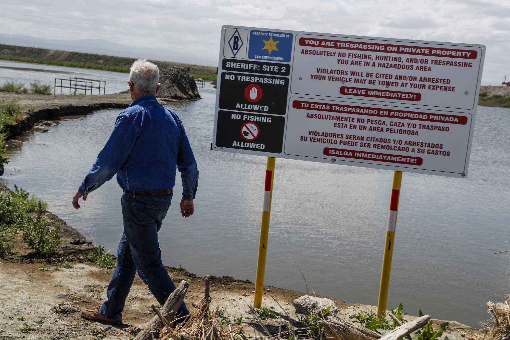 Farmer Charlie Meyer walks toward a levee breach. 