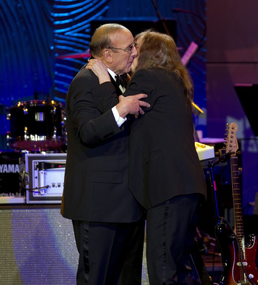 Clive Davis shares a kiss with Patti Smith during Clive Davis and the Recording Academy's 2013 Grammy Salute to Industry Icons Gala held at the Beverly Hilton Hotel on Feb. 9, 2013, in Beverly Hills. MORE: Clive Davis' next role: Broadway producer of a new 'My Fair Lady'