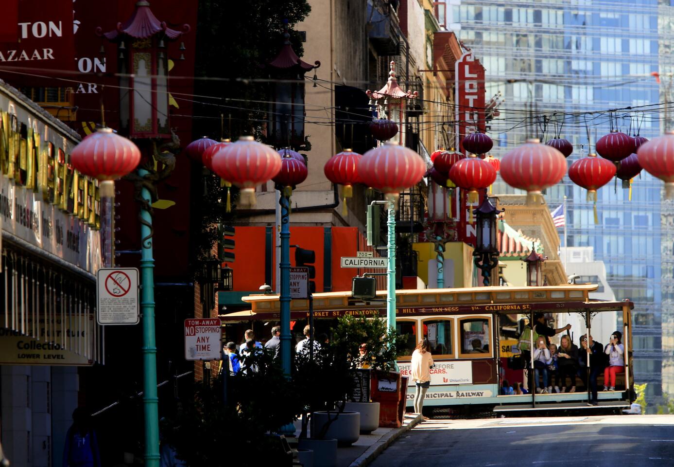 A cable car cruises past Chinatown in San Francisco.