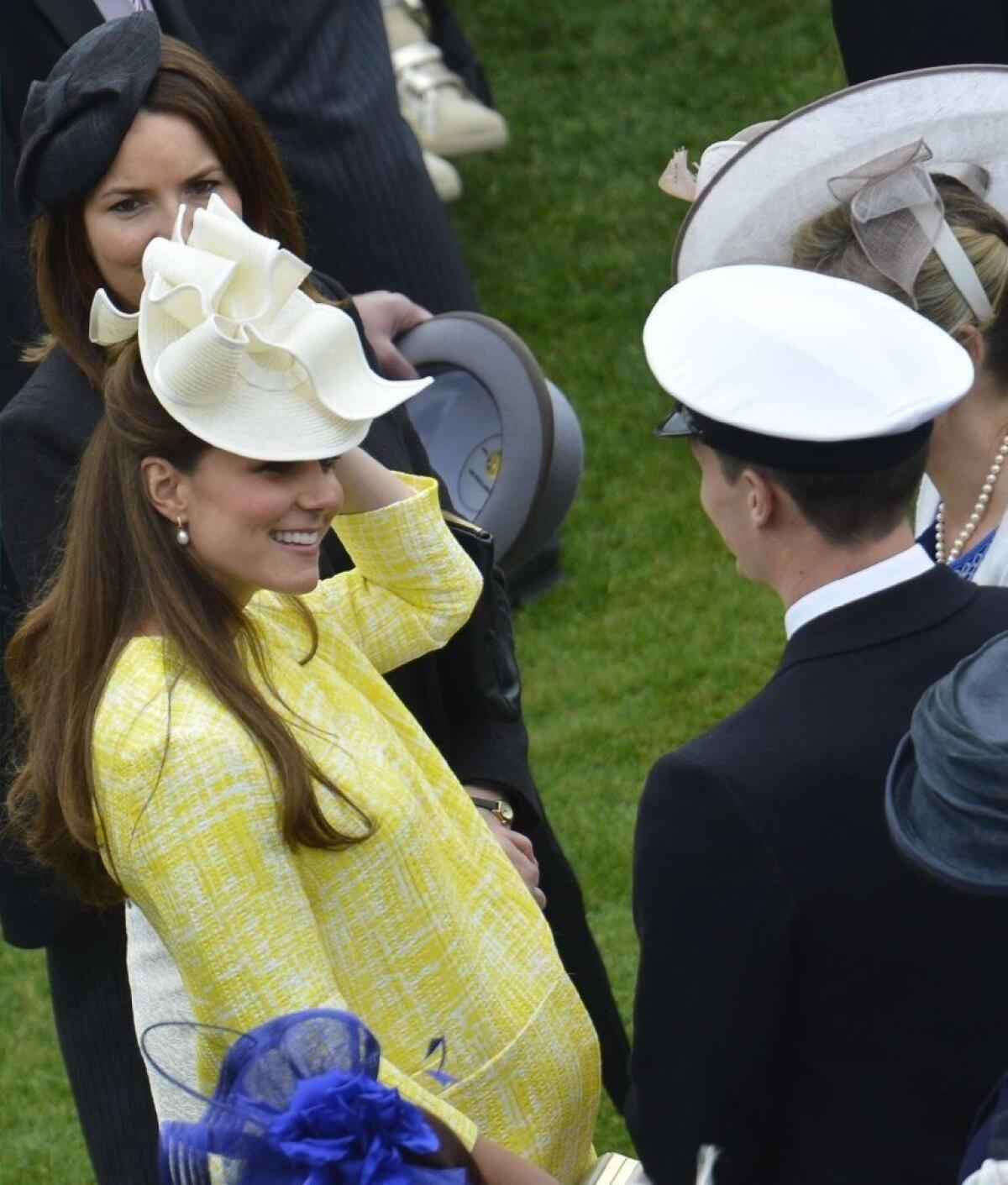 Her royal highness the Duchess of Cambridge, the former Kate Middleton, at a Buckingham Palace garden party, in full maternity mode. Boy or girl, the child will become the future monarch.