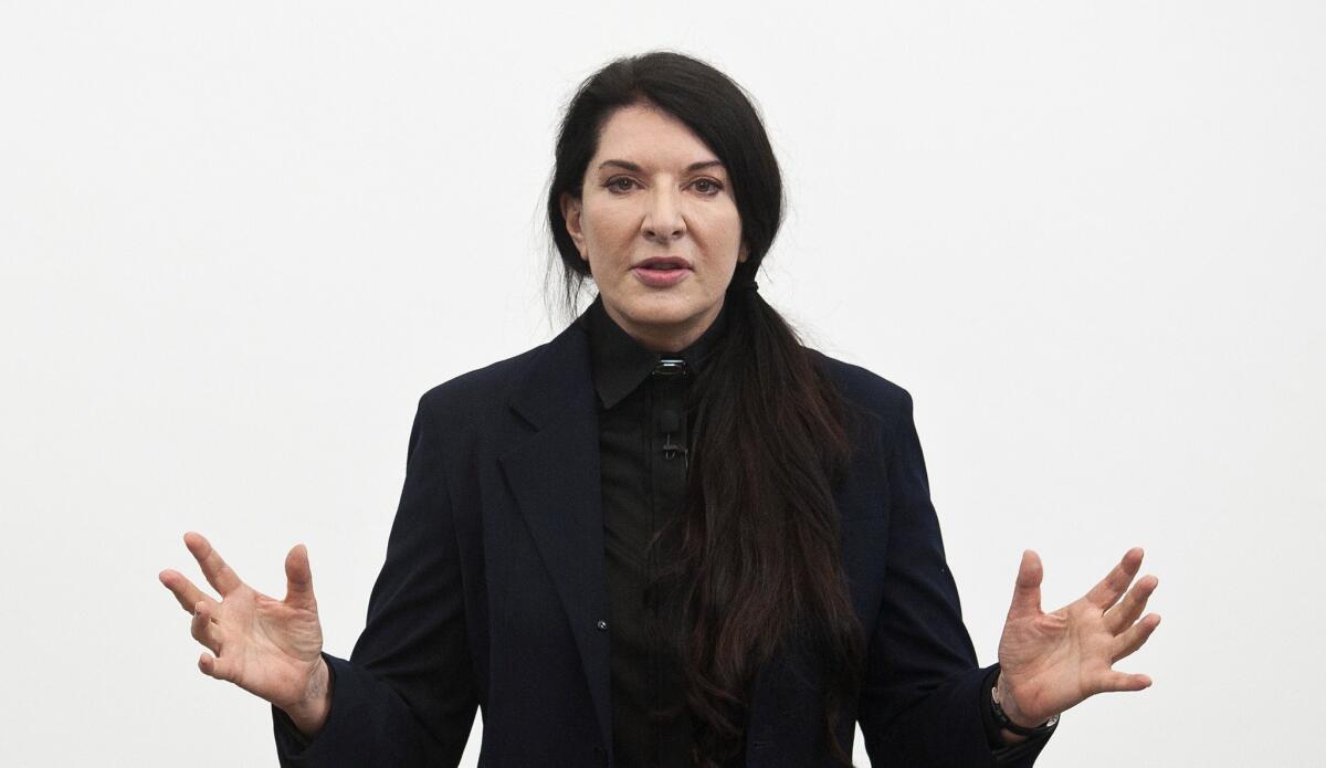 The institute run by performance artist Marina Abramovic has taken flak this week for posting four positions that are all unpaid. The artist is seen above, at a press conference for her ongoing exhibition at the Serpentine Gallery in London.