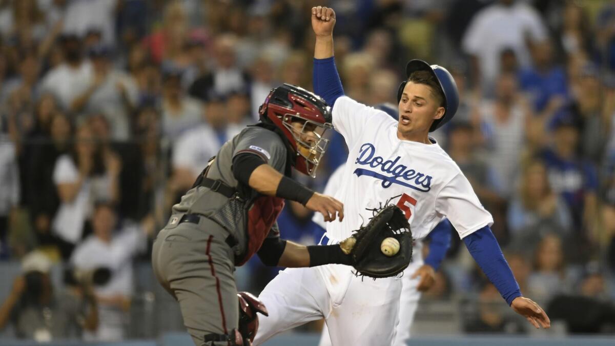 Corey Seager (5) of the Dodgers beats the throw to Alex Avila of the Arizona Diamondbacks to score in the third inning at Dodger Stadium.