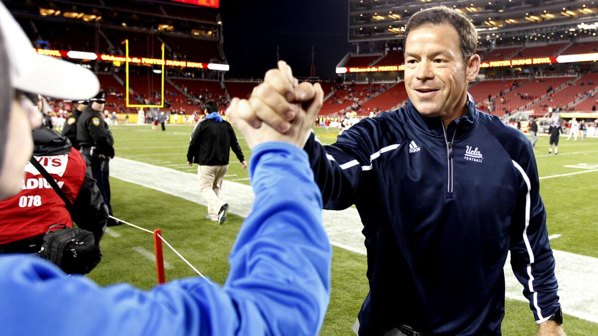 UCLA Coach Jim Mora greets a fan before the Foster Farms Bowl at Levi's Stadium on Saturday.