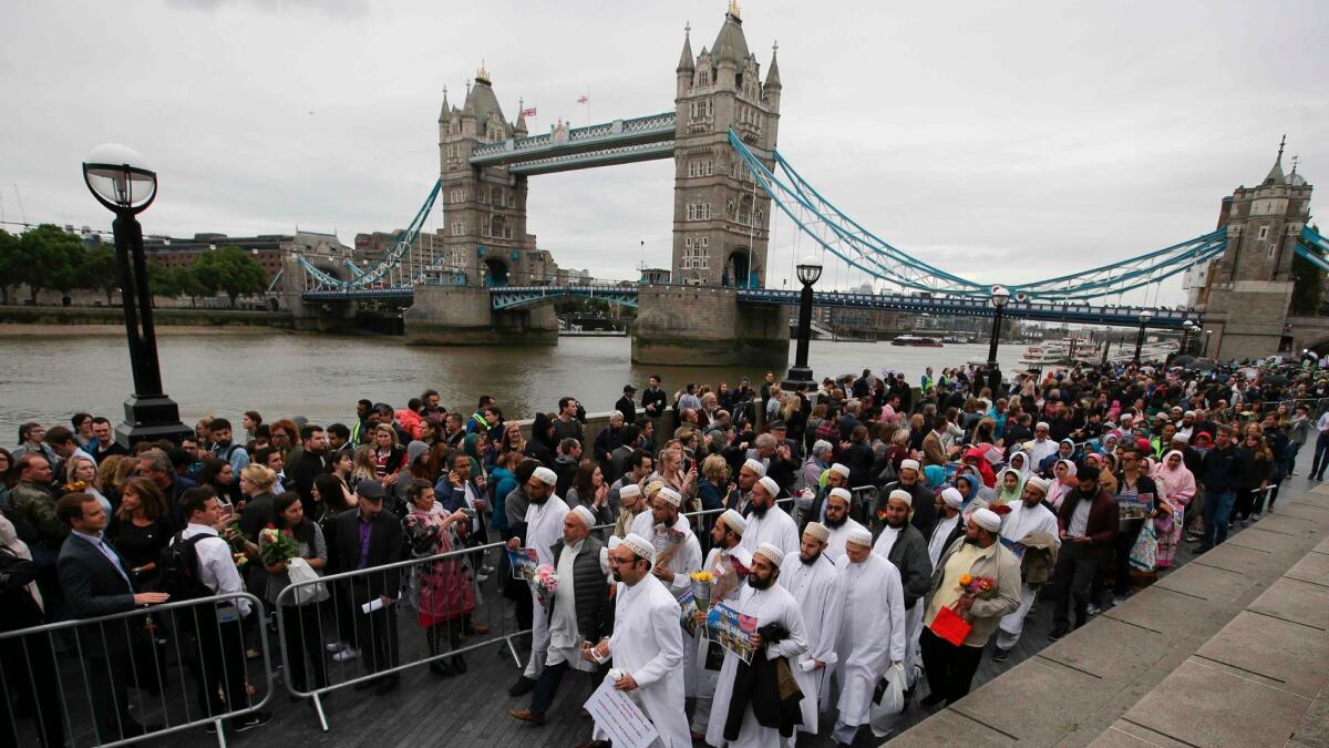 A vigil is held at Potters Fields Park in London on Monday for the victims of the terror attack on London Bridge and at Borough Market.