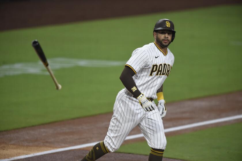 San Diego Padres left fielder Tommy Pham (28) tosses his bat after walking during the first inning of a baseball game against the Seattle Mariners Friday, Sept. 18, 2020, in San Diego. (AP Photo/Denis Poroy)