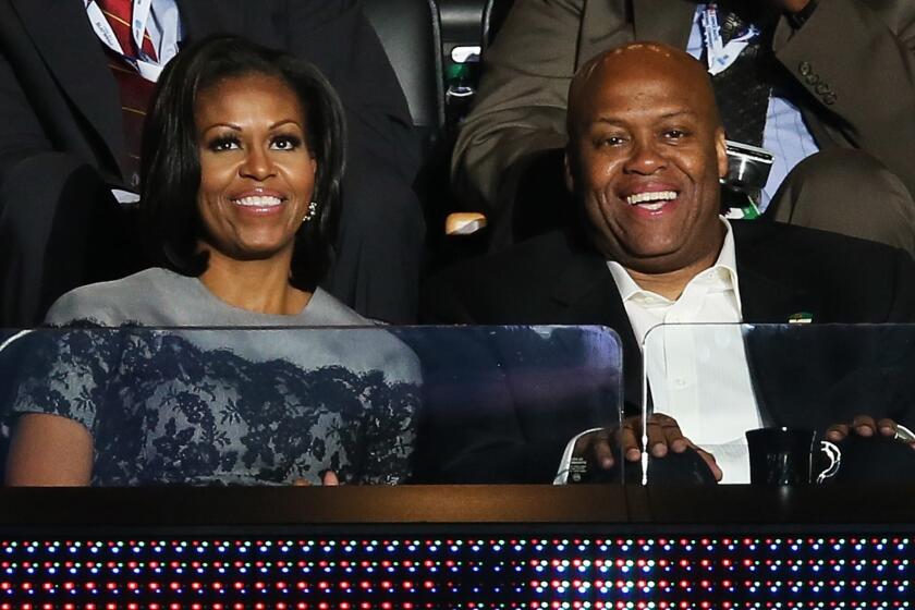 Craig Robinson sits next to his sister, First Lady Michelle Obama, at the 2012 Democratic National Convention.
