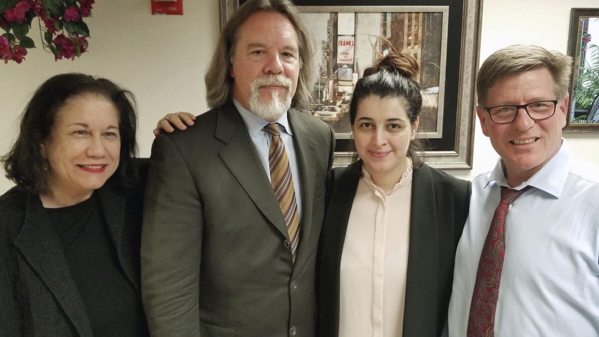 Noor Salman, second from right, and her attorneys pose for a photo on Friday after Salman was acquitted of lying to the FBI and helping her husband attack the Pulse nightclub in Orlando, Fla.