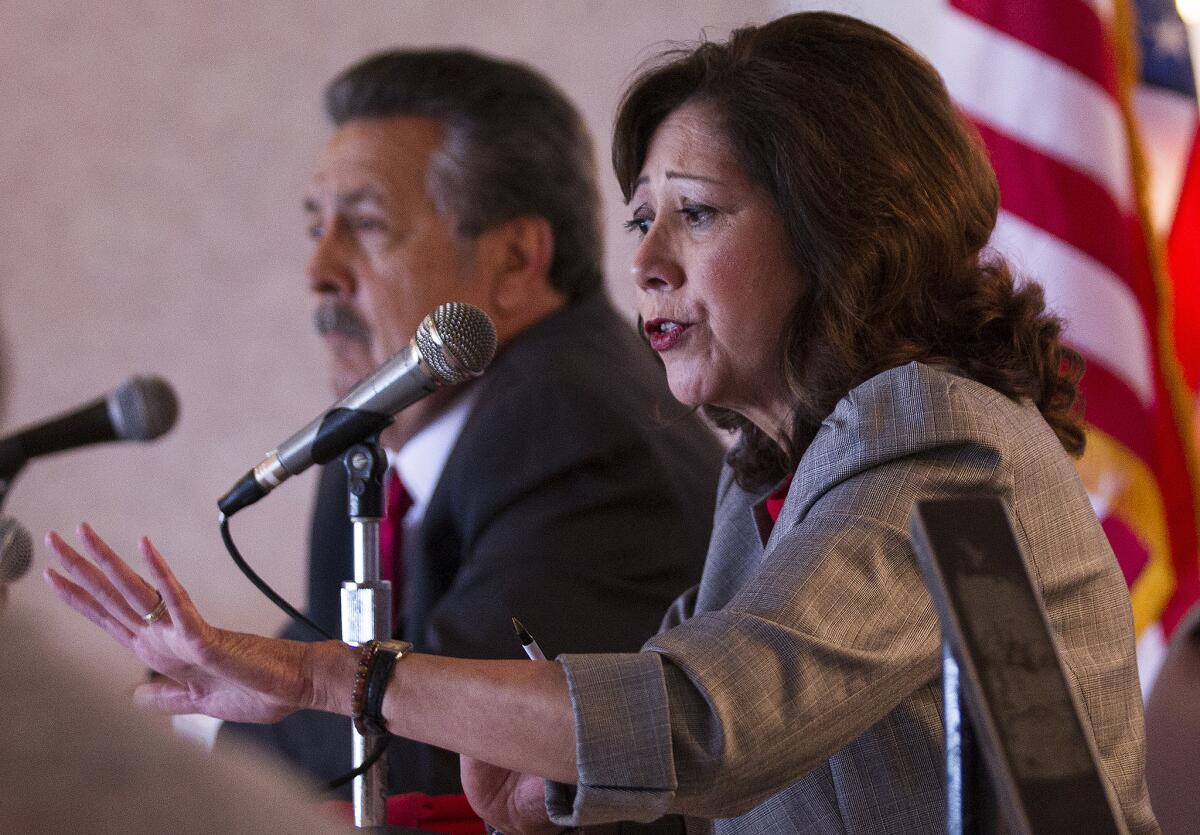 Supervisor candidates Hilda Solis, right, and Juventino "J" Gomez answer questions during a lunch forum in Pomona.