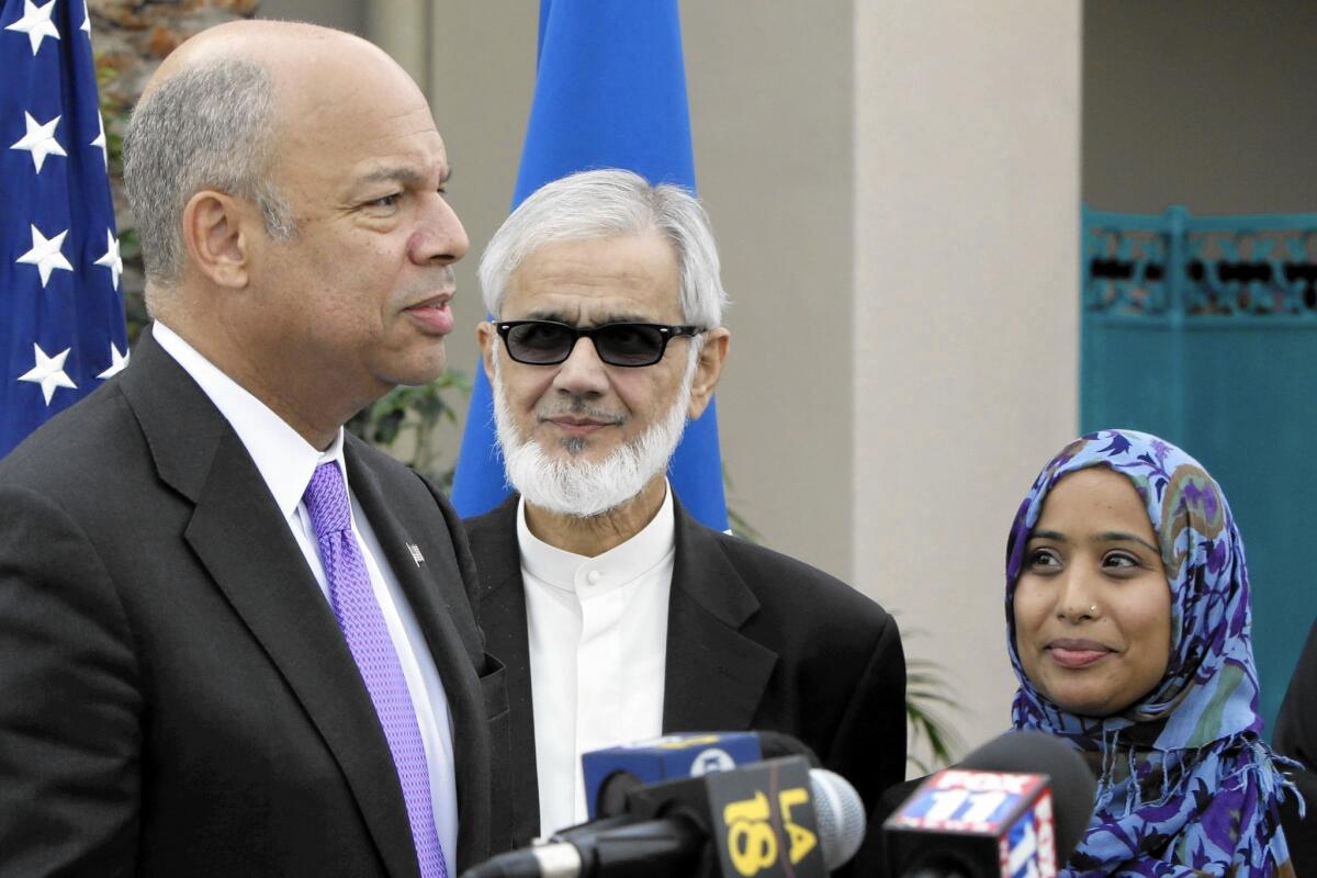 Dr. Muzammil Siddiqui, center, and Dr. Amna Rizvi, right, look on as Homeland Security Secretary Jeh Johnson addresses a news conference outside the Islamic Center of San Gabriel Valley.