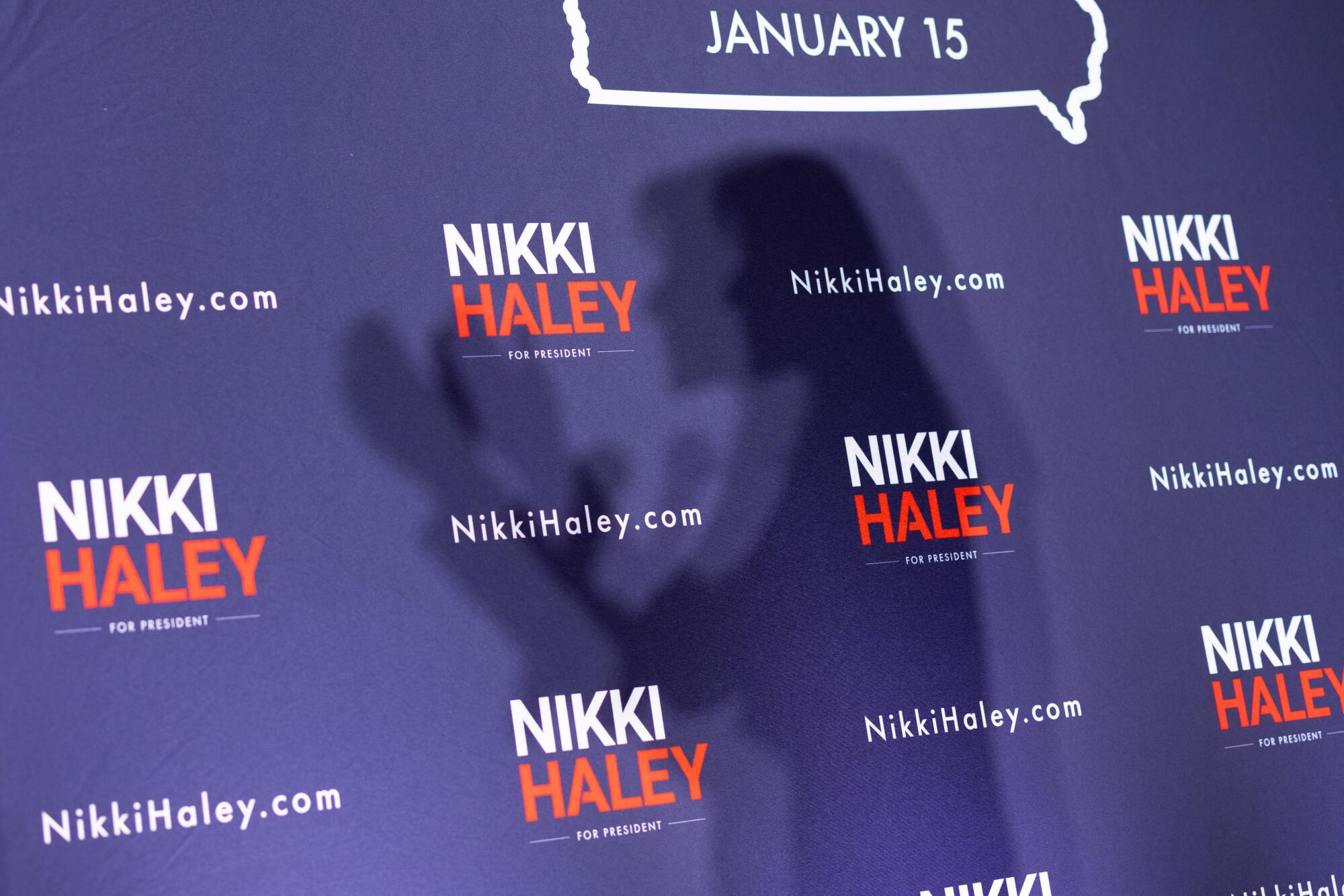 Nikki Haley's shadow on the wall behind her as she speaks at a campaign event