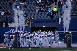 The Dallas Cowboys run onto the field during an NFL football game against the Philadelphia Eagles.