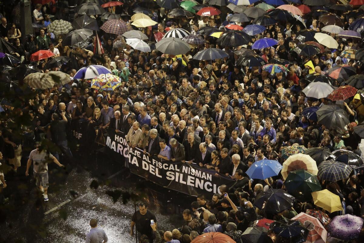 Demonstrators in Buenos Aires hold a banner that reads in Spanish: "Homage to prosecutor Nisman. Silent march" during a march in tribute to deceased prosecutor Alberto Nisman.