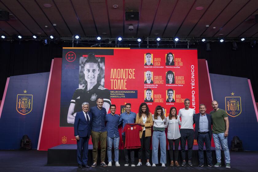 Spain's new women's national team coach Montse Tome, center, holds a jersey during her official presentation with her technical staff at the Spanish soccer federation headquarters in Las Rozas, just outside of Madrid, Spain, Monday, Sept. 18, 2023. Tome replaced Jorge Vilda less than three weeks after Spain won the Women's World Cup title and amid the controversy involving suspended federation president Luis Rubiales who has now resigned. (AP Photo/Manu Fernandez)