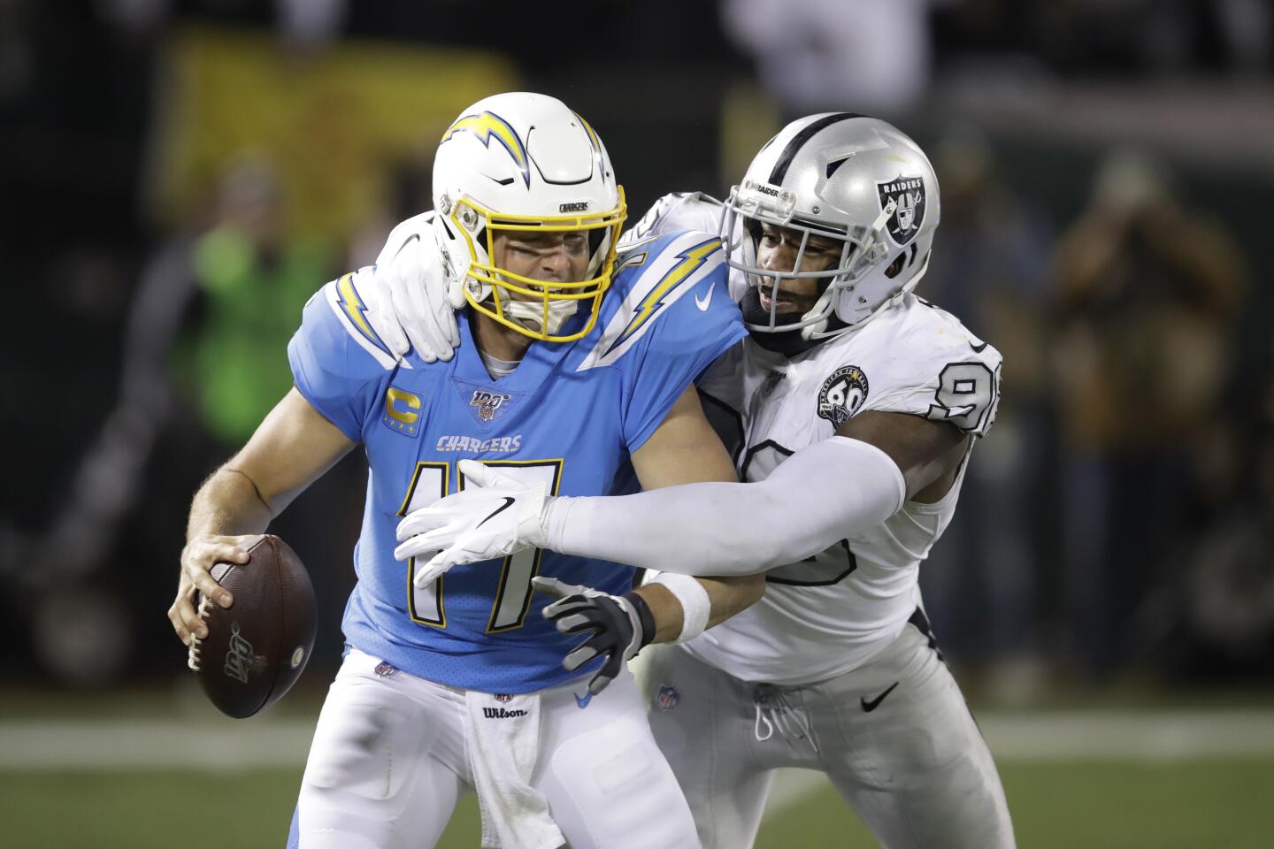 Chargers quarterback Philip Rivers (17) is sacked by Raiders defensive end Clelin Ferrell during the second half of a game Nov. 7 at RingCentral Coliseum.