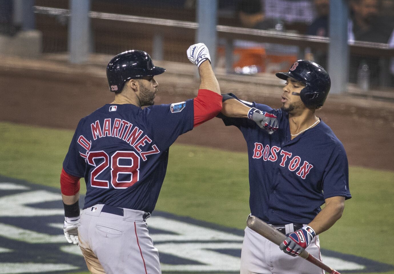 Red Sox right fielder J.D. Martinez, left, is congratulated by teammate Xander Bogaerts after hitting a home run in the seventh inning.