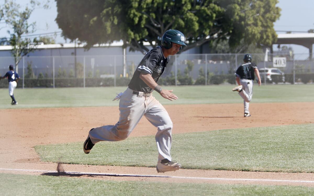Costa Mesa High's Miguel Rodriguez sprints home to score a run in the first inning of an Orange Coast League game against Calvary Chapel at TeWinkle Park on Wednesday