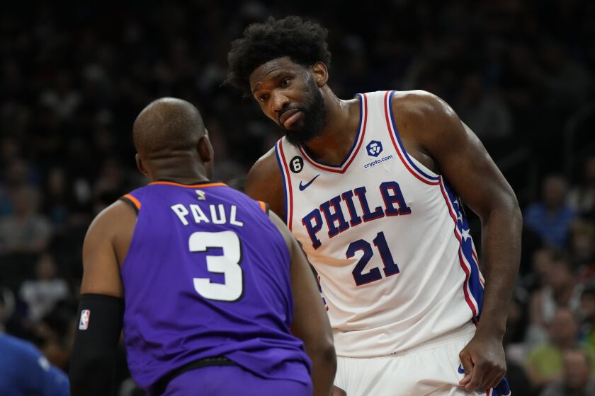 Phoenix Suns guard Chris Paul (3) and Philadelphia 76ers center Joel Embiid have words during the first half of an NBA basketball game Saturday, March 25, 2023, in Phoenix. (AP Photo/Rick Scuteri)