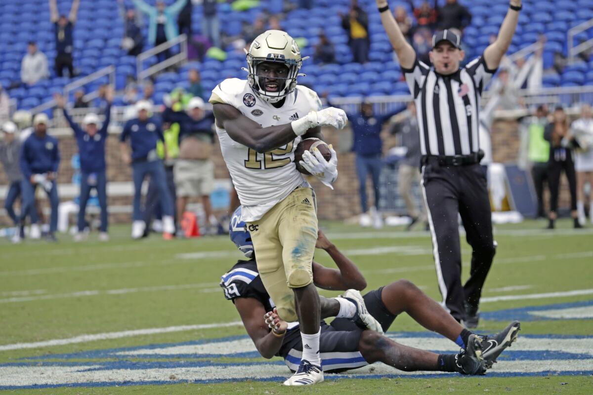 Georgia Tech wide receiver Adonicas Sanders (12) starts to celebrate after he caught a pass for what proved to be the winning touchdown against Duke cornerback Jeremiah Lewis (39) during the second half of an NCAA college football game in Durham, N.C., Saturday, Oct. 9, 2021. (AP Photo/Chris Seward)